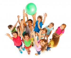 Group of kids catching green ball